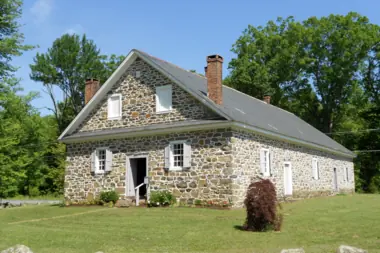 A historic stone building and lawn in Warrington Township.