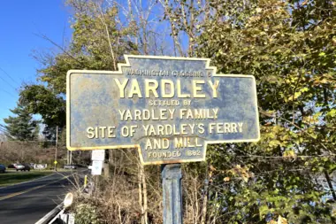 A historic Yardley Borough marker beside a tree-lined road.